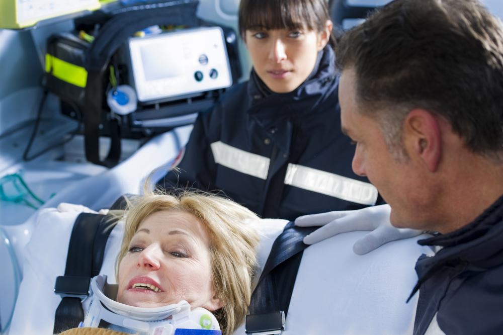 woman in ambulance with neck brace
